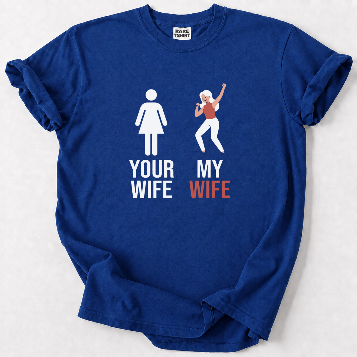 A royal blue short-sleeve t-shirt with a graphic print on the front. The graphic features a white female silhouette labeled 'YOUR WIFE' next to a white male silhouette with sunglasses and a drink labeled 'MY WIFE' in orange-red.