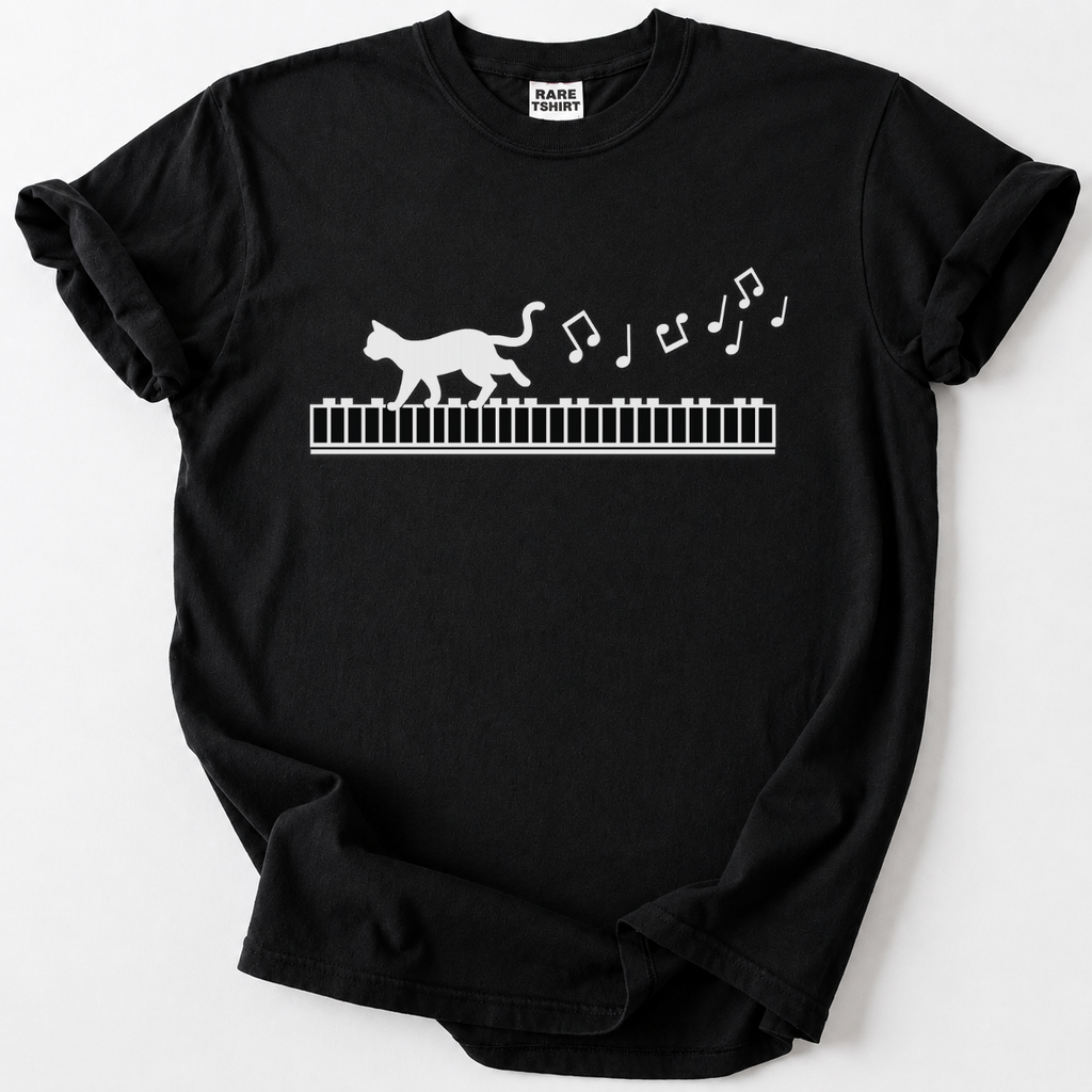 Whimsical cat-on-piano graphic tee for music lovers. Soft, premium cotton comfort meets rare artistic design. The perfect gift for pianists &amp; cat lovers.