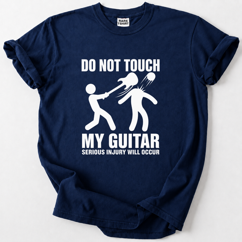 A navy blue short-sleeve t-shirt with a white graphic print that reads 'DO NOT TOUCH MY GUITAR SERIOUS INJURY WILL OCCUR' accompanied by a stick figure illustration of a guitar fight. The shirt is laid flat on a light gray background.