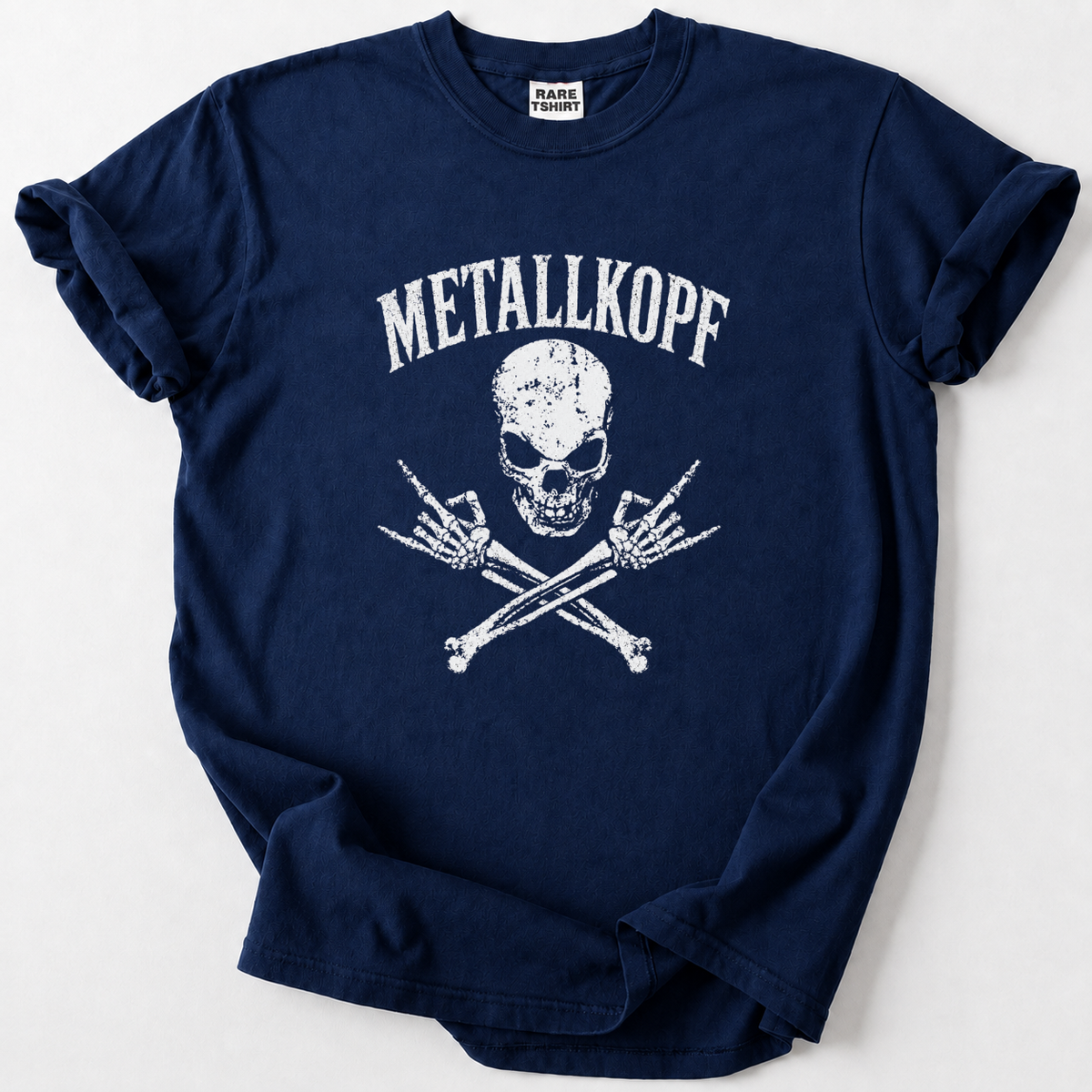 A navy blue short-sleeve t-shirt with a distressed white graphic of a skull and crossed bones with the text 'METALLKOPF' above it, laid flat on a light gray background.
