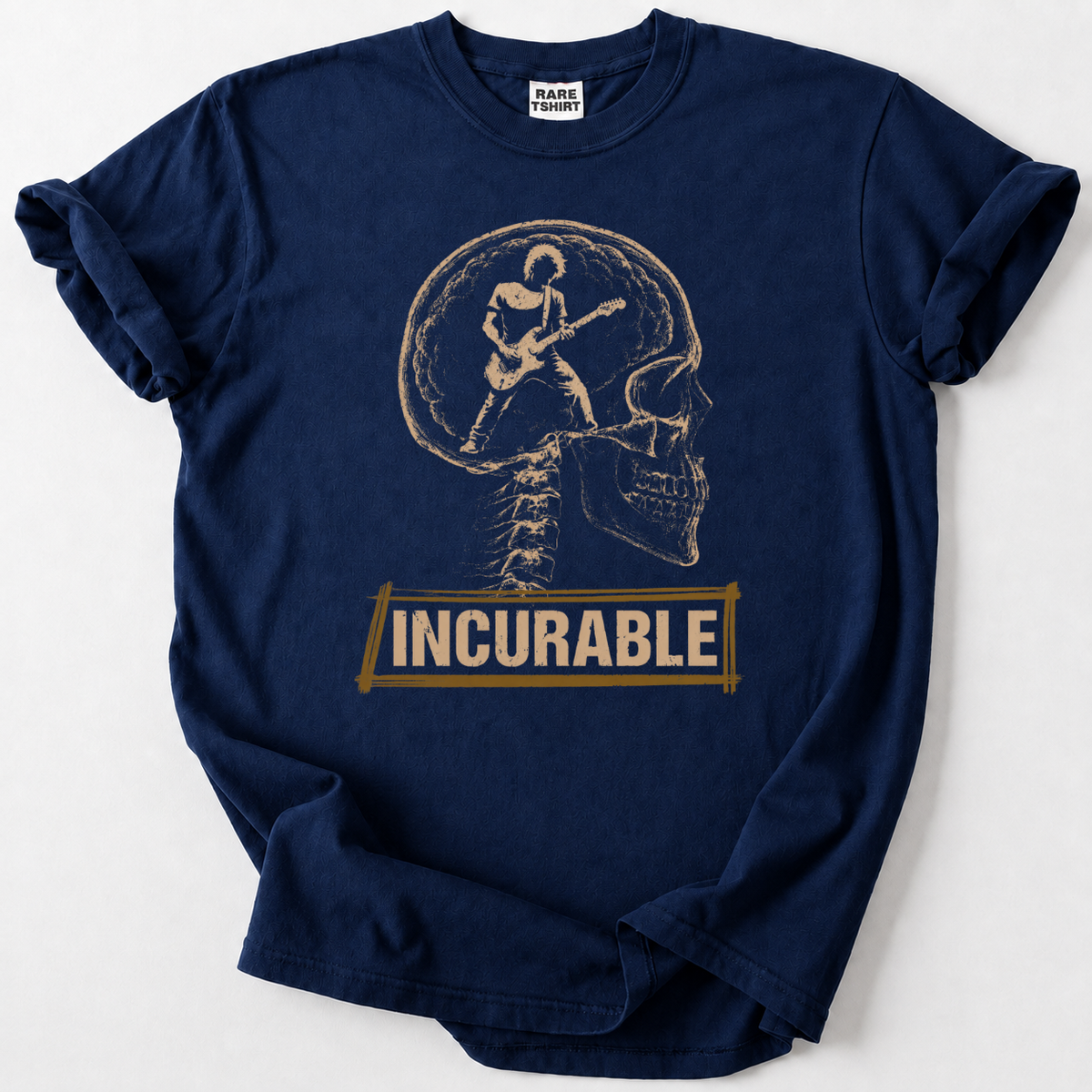 A navy blue t-shirt with a graphic print of a skull and spine featuring a guitarist inside, with the word 'INCURABLE' printed below in a gold banner. The shirt is laid flat on a light gray background.